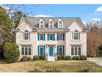 Charming two-story home with a brick facade, blue shutters, and a well-maintained front yard at 108 Finnway Ln, Cary, NC 27519