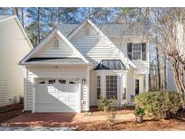 Charming home featuring a well-manicured lawn and a two-car garage at 1208 Copper Creek Dr, Durham, NC 27713