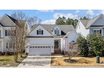 Charming two-story home with a well-manicured lawn, attached garage, and inviting curb appeal at 153 Sharp Top Trl, Apex, NC 27502