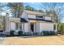 Charming two-story home with light siding, dark trim, and landscaped front yard at 1615 Old Barn Rd, Rocky Mount, NC 27804