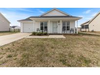 Charming single-story home with white siding, front porch, and well-maintained lawn at 2425 Shreve Rd, Rocky Mount, NC 27801