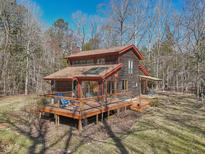 Charming two-story cabin home with a spacious deck, perfect for enjoying the natural surroundings at 279 Box Turtle Trl, Chapel Hill, NC 27516