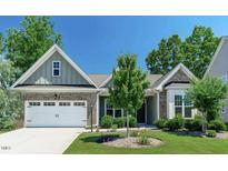Charming single-story home features a well-manicured lawn, lovely landscaping, and an attached two-car garage at 2851 Wilkes Lake Dr, Fuquay Varina, NC 27526