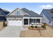 Charming single-Gathering home with a well-manicured front yard and attached two-car garage at 2907 Jakes View Pt, Fuquay Varina, NC 27526
