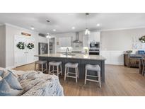 Bright kitchen with large island, granite countertops, and stainless steel appliances at 2907 Jakes View Pt, Fuquay Varina, NC 27526
