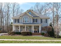 Charming two-story home featuring a welcoming front porch and classic architectural details at 4228 Bibleway Ct, Holly Springs, NC 27540