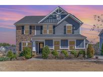 Charming two-story home with stone and siding, complemented by lush landscaping at 710 Legacy Falls S S Dr, Chapel Hill, NC 27517