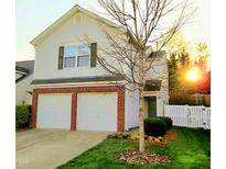 Charming two-story home with a two-car garage, brick accents, and well-maintained lawn at 9125 Colony Village Ln, Raleigh, NC 27617
