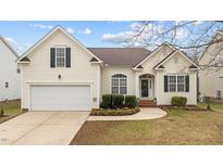 Charming home featuring a well-maintained lawn, attached garage and inviting front entrance at 9208 Cornwell Dr, Wake Forest, NC 27587