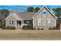 Charming single-Gathering home with brick and siding, featuring well-maintained landscaping and a welcoming entrance at 1028 Allaire Dr, Raleigh, NC 27603