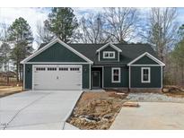 Charming one-story home featuring an attached two-car garage and a beautifully landscaped yard at 109 Averly Ct, Stem, NC 27581