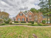 Charming brick home featuring a beautifully landscaped front yard and classic architectural details at 1201 Clematis St, Knightdale, NC 27545