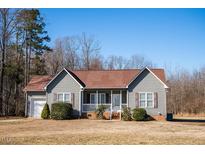 Charming single Gathering home with an attached garage, manicured lawn and well-maintained landscaping at 159 Valhalla Dr, Timberlake, NC 27583