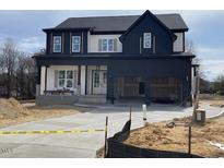 Two-story home showcasing a modern exterior design with a spacious two car garage and concrete driveway at 2300 Eagle Shot Ct # 25, Fuquay Varina, NC 27526