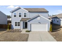 Charming two-story home features light blue siding, a two-car garage, and a well-manicured lawn at 3517 Strawberry Patch Row, Raleigh, NC 27604