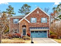 Charming two-story brick home with a two-car garage and well-maintained landscaping at 3614 Kilgo Dr, Durham, NC 27705