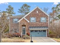 Charming two-story brick home with blue shutters and attached two-car garage at 3614 Kilgo Dr, Durham, NC 27705