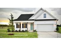 Charming new construction home featuring a lovely exterior, green lawn, black shutters and a two car garage at 37 Mossman Ct, Zebulon, NC 27597