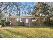 Charming brick home with red shutters and a well-manicured lawn at 3719 Hermine St, Durham, NC 27705