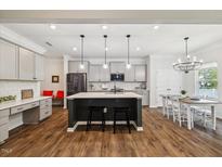 Bright, open kitchen with a large island, modern appliances, and a dining area at 3800 Cross Timber Ln, Raleigh, NC 27603