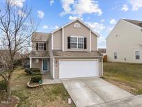 Charming two-story home featuring a two-car garage and landscaped front yard at 3811 Chehaw Dr, Raleigh, NC 27610