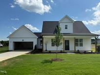 Charming single-Gathering home with a manicured lawn and inviting curb appeal under a sunny sky at 432 Springtooth Dr, Zebulon, NC 27597