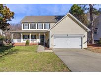 Charming two-story home with a welcoming front porch and attached two-car garage at 5401 Green Feather Ln, Raleigh, NC 27604