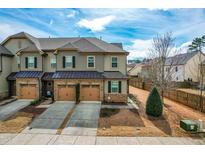 Attractive townhome featuring attached two-car garages and stone accents at 761 Wickham Ridge Rd, Apex, NC 27539
