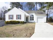 Charming one-story home with white siding, brown shutters, and a well-manicured front yard at 104 Hickory Glen Ln, Durham, NC 27703