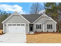 Charming single-story home with gray siding, white trim, and an attached two-car garage at 111 Averly Ct, Stem, NC 27581