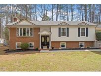 Charming two-story home with brick and siding exterior, manicured lawn, and double door entrance at 1203 Brookgreen Dr, Cary, NC 27511
