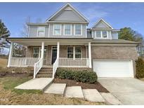 Charming two-story home with a welcoming front porch and a well-manicured lawn at 135 N Ridge View Way, Franklinton, NC 27525