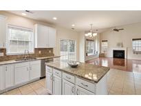 Bright eat-in kitchen with island, granite countertops, white cabinets and stainless steel appliances at 2017 Ollivander Dr, Cary, NC 27519