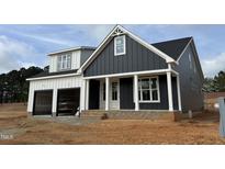 Stunning two-story home with a two-car garage, covered entry, and modern design accents at 2313 Eagle Shot Ct # 29, Fuquay Varina, NC 27526