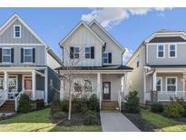 Charming two-story home with a welcoming front porch and well-manicured lawn at 237 Daniel Ridge Rd, Wendell, NC 27591