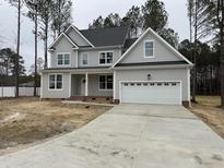 Charming two-story home with a large garage and beautifully landscaped yard at 25 Arbor Dr, Youngsville, NC 27596