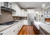 This kitchen features white cabinets, stainless steel appliances, and granite countertops at 260 Culbreth Rd, Chapel Hill, NC 27516