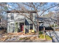 Charming two-story home featuring a carport, bench, manicured yard and walkway at 2925 Rue Sans Famille, Raleigh, NC 27607