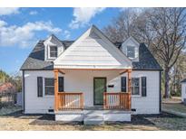 Charming two-story home featuring a cozy front porch with wooden pillars and dark shutters at 328 Cleveland St, Rocky Mount, NC 27803