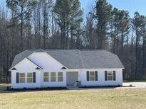 Charming single-story home with white siding, black shutters, and a well-manicured lawn at 343 Magnolia Run Way, Benson, NC 27504