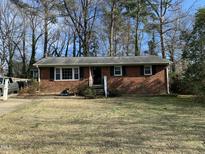 Charming single-story brick home featuring tidy landscaping and an inviting front entrance at 3500 Carolyn Dr, Raleigh, NC 27604