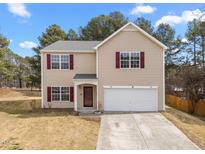 Charming two-story home with red shutters, a manicured lawn, and an attached two-car garage at 4207 Hampstead Village Dr, Durham, NC 27703