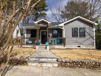 Charming gray home with a welcoming front porch and stone walkway leading to the entrance at 611 Dunbar St, Durham, NC 27701