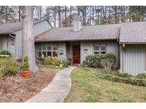 Charming single story home with a welcoming entrance and beautiful surrounding landscaping at 7925 Brown Bark Pl, Raleigh, NC 27615