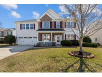 Charming two-story home features a well-manicured lawn, red shutters and a two-car garage at 80 Ingle View Ct, Burlington, NC 27215