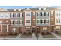 Townhome exterior showing brick facade, gray siding, and black shutters at 978 Gateway Commons Cir, Wake Forest, NC 27587