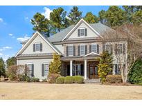 Beautiful two-story home featuring stone accents, a gabled roof, and a well-manicured front yard at 105 Jessfield Pl, Cary, NC 27519