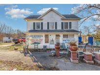 Charming two-story building with white siding, green shutters, and appealing business frontage at 120 Lake Orange Rd, Hillsborough, NC 27278