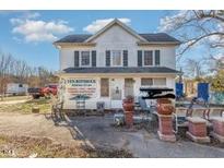 Two-story home featuring light colored siding, dark shutters, and manicured landscaping at 120 Lake Orange Rd, Hillsborough, NC 27278