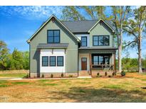 Inviting two-story home showcasing a modern color scheme and well-manicured landscaping at 1403 Antioch Church Rd, Timberlake, NC 27583